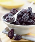 White Bowl of prunes with spoon — Stock Photo