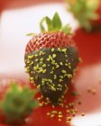 Closeup view of strawberry dipped in chocolate with pistachio — Stock Photo