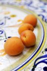 Four raw apricots — Stock Photo
