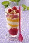 Peach Melba in cup with red spoon over cloth — Stock Photo