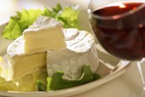Camembert on plate with wine — Stock Photo