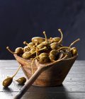 Giant capers in wooden bowl — Stock Photo
