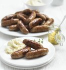 Pork Sausages with smashed potatoes — Stock Photo