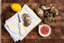Raw Oysters with lemon and sauce — Stock Photo