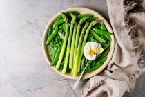 Varietà di verdure verdi cotte asparagi, piselli, baccello di pisello, serviti con pane e uova in camicia — Foto stock