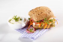 Wholemeal roll with cream cheese and egg spread, radishes and cress — Stock Photo