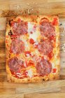 Close-up shot of delicious Flatbread pizza with salami — Stock Photo