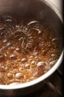 Caramel boiling in a pot — Stock Photo