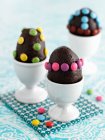 Chocolate eggs with colorful chocolate beans — Stock Photo