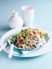 Couscous salad with lemon, cucumber, tomato, yogurt, onion and herbs — Stock Photo