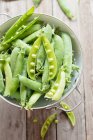 Green Peas in a bowl — Stock Photo
