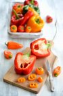 Red and yellow peppers, partly sliced — Stock Photo