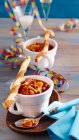 Spicy bean soup with sausages served with yeast dough and puff pastry Parmesan sticks — Foto stock