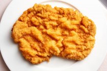 A Viennese escalope on a plate (seen from above) — Stock Photo