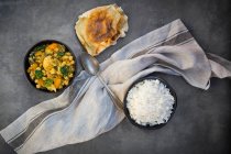 Vegetable curry with cauliflower, butternut squash, spinach and coriander served with poppadum's and rice — Stock Photo