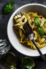 Fettuccine pasta with lemon and basil sauce. Sprinkled with parmesan and black pepper — Stock Photo