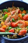 Shrimps with tomatoes, quinoa and basil leaves — Stock Photo