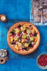 The ultimate Vegetarian Christmas Pie with courgette ribbons, butternut squash, beetroot and leeks, topped with feta cheese and pomegranate seeds — Stock Photo