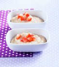 Portions of spelt porridge with cut strawberry pieces — Stock Photo