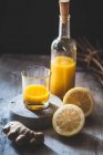 Detox and ginger shots with ginger juice, orange juice, lemon juice, turmeric and chili — Stock Photo