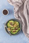 Green pancakes with banana and chocolate sauce — Stock Photo