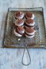 Macarons with chocolate cream and cocoa powder — Stock Photo