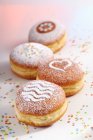 Doughnuts for carnival with various icing sugar patterns — Stock Photo