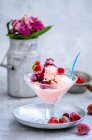 Homemade berry ice cream served with frozen berries — Stock Photo
