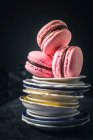 Three pink macaroons on plates stack — Stock Photo