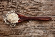 Quinoa flour on a wooden spoon — Stock Photo