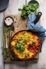 Vegan pie with tomatoes, red kidney beans, corn spiced with smoked paprika and cumin and topped with polenta, spring onions, chilli and coriander — Stock Photo