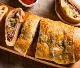 Stromboli stuffed with sausage and vegetables (top view) — Stock Photo