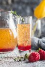Alcohol berry drink with blueberries, raspberries and seeds — Stock Photo