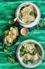 Ravioli with spinach, served with pini nuts — Stock Photo