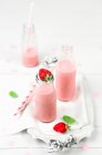 Strawberry smoothie in glass bottles — Stock Photo