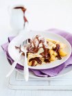Crepes with chocolate sauce, pears and pecans — Stock Photo