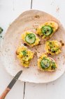 Open sandwiches topped with a turmeric spread, cucumber slices and cress — Stock Photo