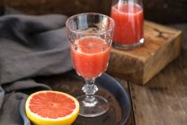 Grapefruit juice and half a grapefruit — Stock Photo