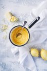 Lemon Curd in Saucepan, light background — Stock Photo