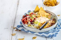 Taco salad bowl with chili peppers, rice, beans, corn and nachos — Stock Photo