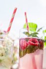 Glasses of raspberries and mint infused water — Stock Photo