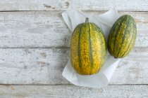 Close-up shot of delicious Two squashes on white paper — Stock Photo