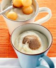 Semolina pudding with cinnamon sugar and melon balls — Stock Photo
