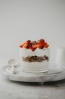 Yoghurt with granola, chia seeds and strawberries in glass — Stock Photo