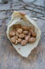 Homemade roasted almonds in a paper bag — Stock Photo