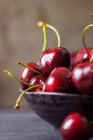 Fresh cherries with water drops in small bowl — Stock Photo