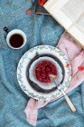 Raspberries cake with a cup of tea and a book — Stock Photo