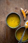 Turmeric tea in a bowl on a wooden background. — Stock Photo