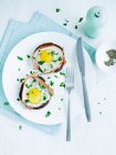 Portobello mushrooms with fried eggs inside served on plate with cutlery — Stock Photo
