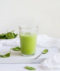 Green spinach smoothie in glass — Stock Photo